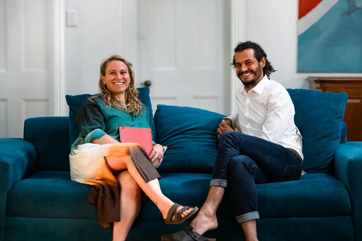 Mikhaela Levitas and Jon from The fVnnel team, smiling on a sofa