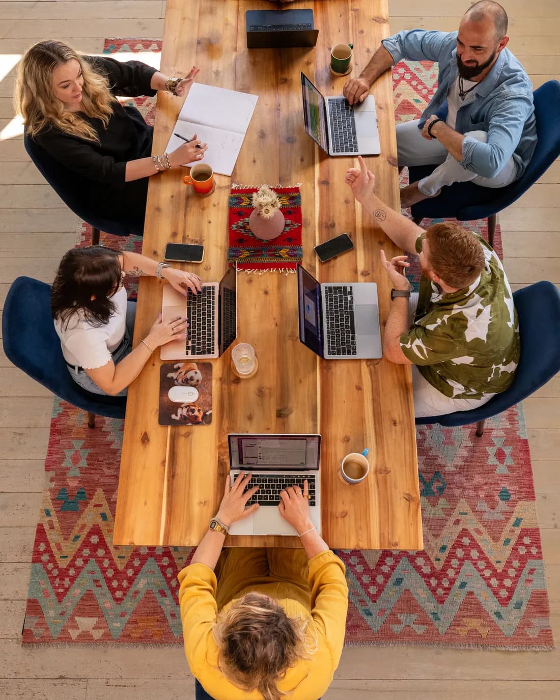 The fVnnel team at work around a shared table, seen from above